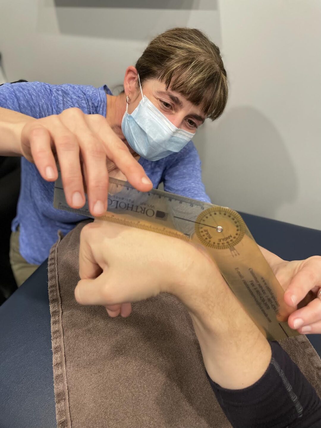 Cathy Sajtos, Hand therapist, measuring writing range of motion Hand therapist using a measuring tool to determine wrist range of mobility.